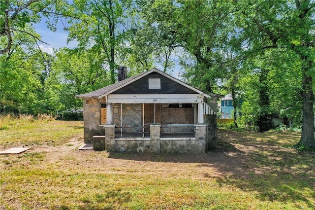 1162 Joseph E Boone Blvd NW, Atlanta, GA 30314 - view of front of home featuring stone siding, a sunroom, a chimney, and a front yard
