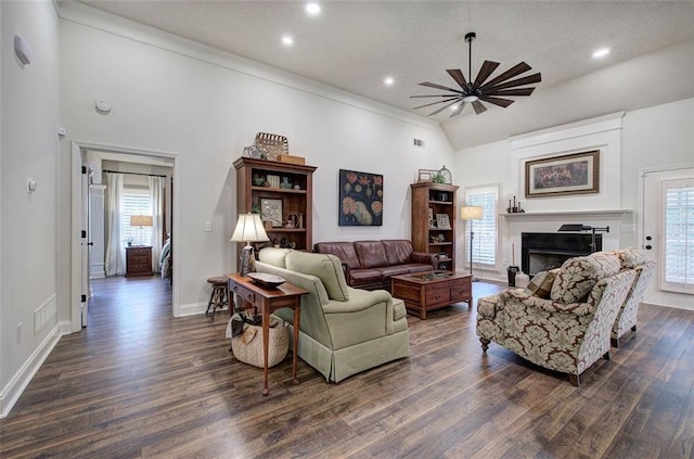 living room featuring dark wood-style flooring, ceiling fan, a fireplace, recessed lighting, and baseboards
