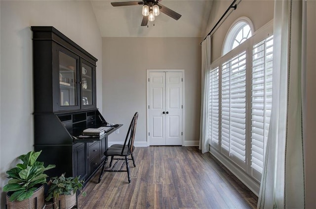 office area featuring a heating unit, baseboards, ceiling fan, dark wood-type flooring, and vaulted ceiling