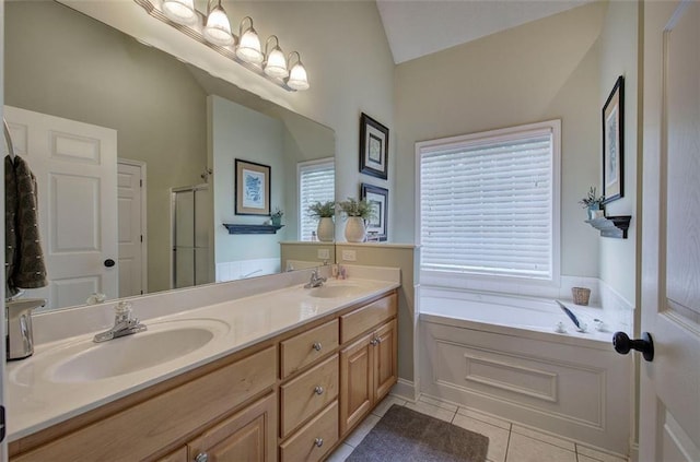 bathroom with double vanity, tile patterned floors, a shower stall, and a sink