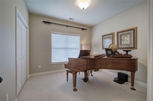 home office with visible vents, carpet flooring, baseboards, and a textured ceiling