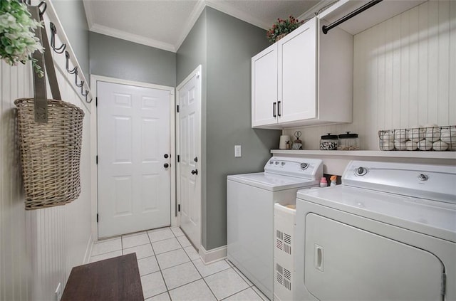 laundry area featuring cabinet space, baseboards, ornamental molding, and washer and dryer
