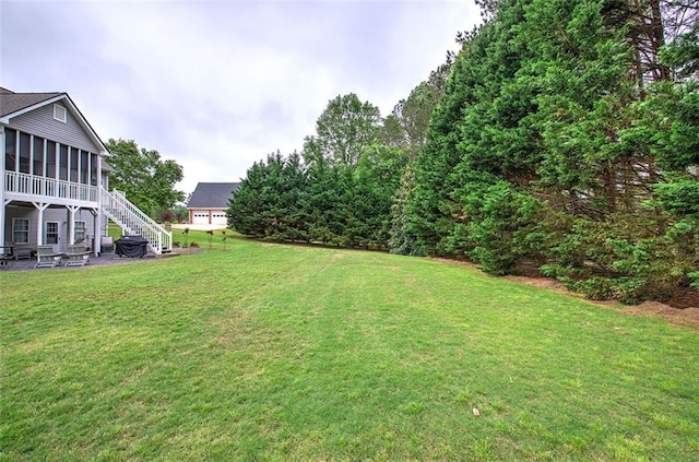 view of yard featuring stairs and a sunroom