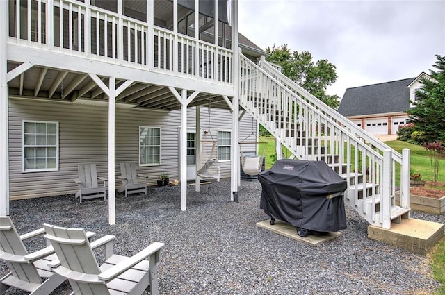 view of patio featuring a grill and stairway