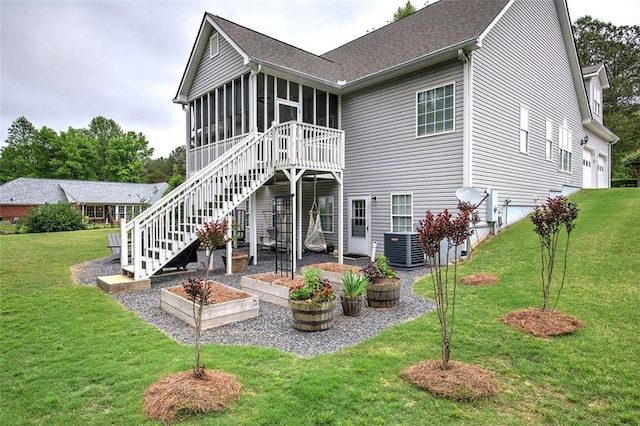 rear view of property featuring stairway, roof with shingles, a yard, and a sunroom