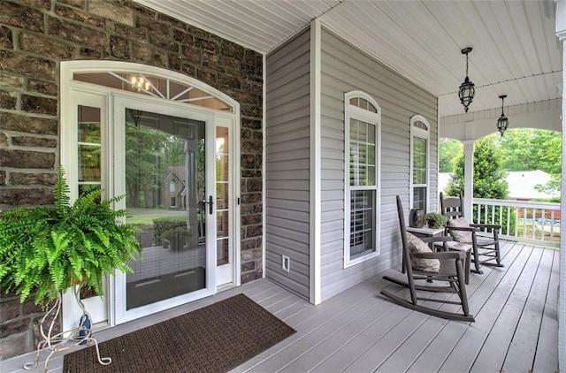 property entrance featuring covered porch and stone siding