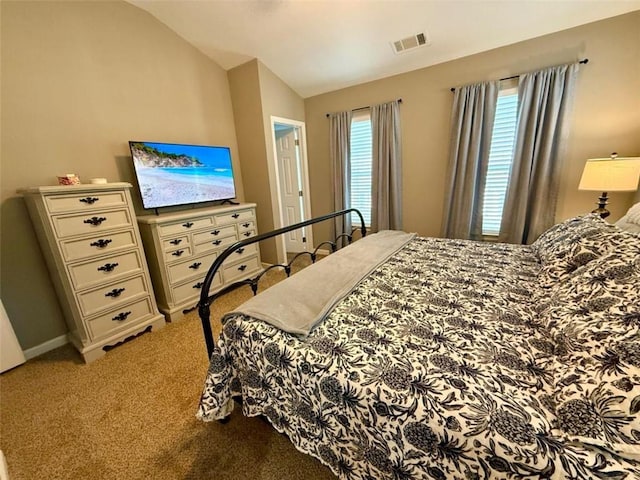 bedroom featuring light carpet and lofted ceiling