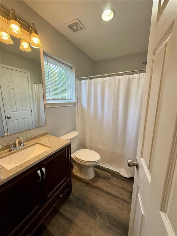 bathroom with wood finished floors, vanity, toilet, recessed lighting, and a shower with shower curtain
