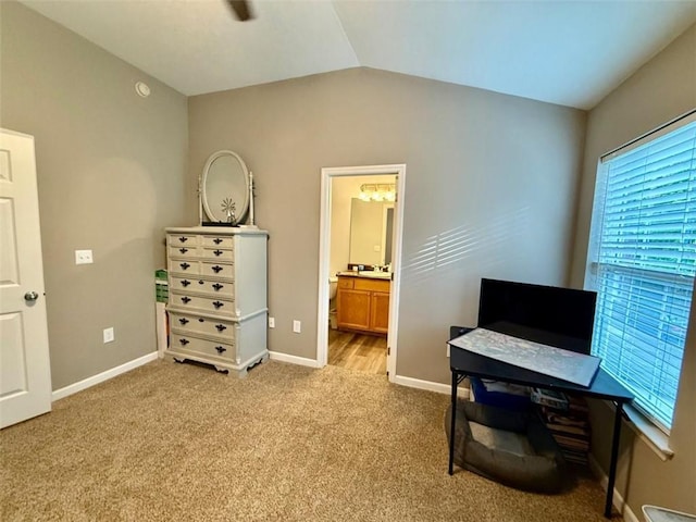 office area with vaulted ceiling, carpet, and baseboards