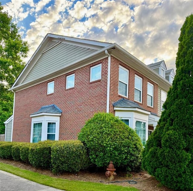 view of side of home with brick siding