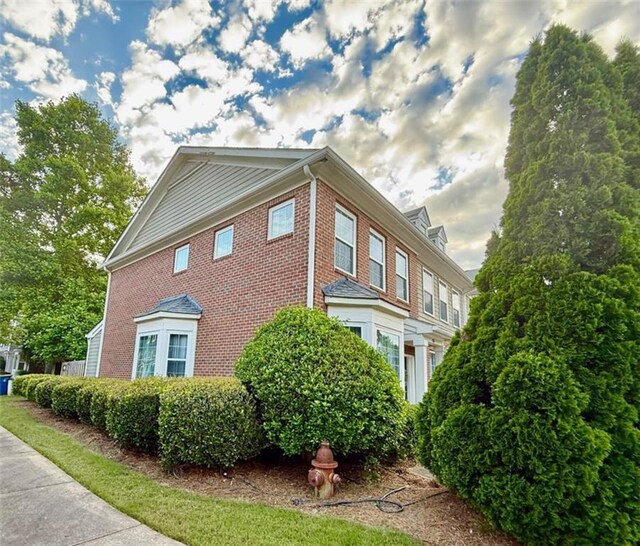 view of home's exterior with brick siding
