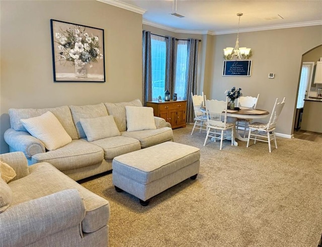 living room with a chandelier, crown molding, arched walkways, light carpet, and baseboards