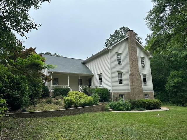 2377 Centerville Rosebud Rd, Loganville, GA 30052 - view of property exterior with a yard, a chimney, and a porch