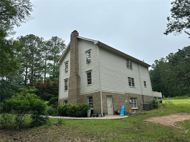 2377 Centerville Rosebud Rd, Loganville, GA 30052 - view of side of property featuring a chimney, a lawn, and brick siding