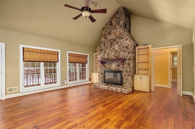 unfurnished living room with ceiling fan, a fireplace, wood-type flooring, and high vaulted ceiling