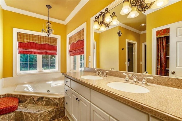 bathroom with an inviting chandelier, ornamental molding, tiled tub, and vanity