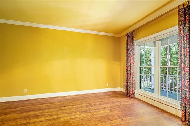 unfurnished room with wood-type flooring and ornamental molding