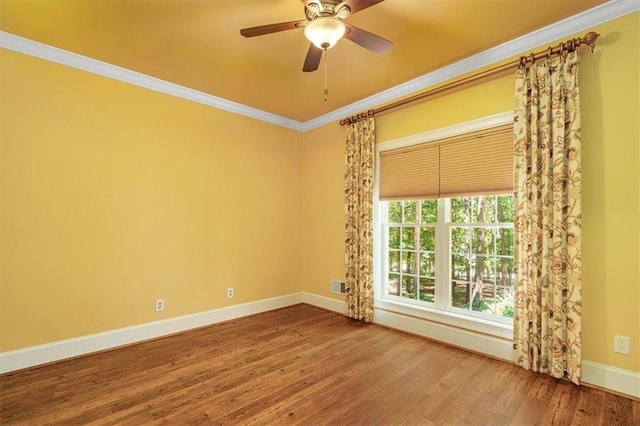 empty room featuring ceiling fan, ornamental molding, and hardwood / wood-style floors