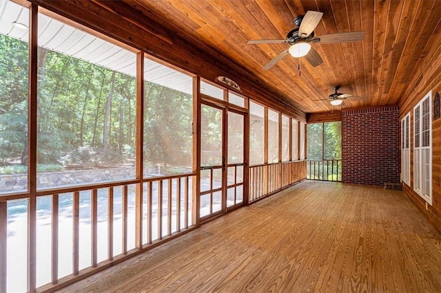 unfurnished sunroom with a wealth of natural light and wooden ceiling