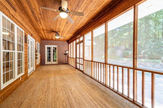 unfurnished sunroom featuring wooden ceiling and ceiling fan