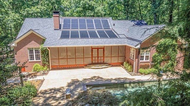 rear view of house with solar panels