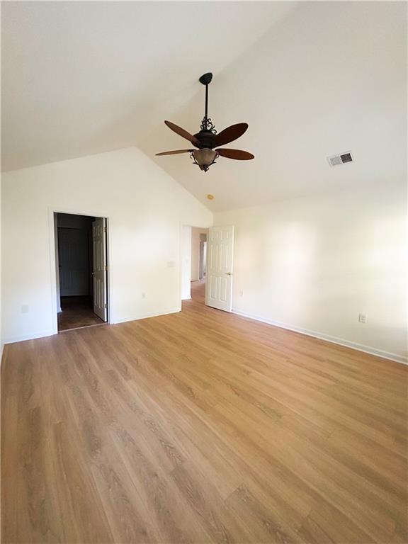 3077 Oakside Cir, Alpharetta, GA 30004 - spare room featuring a ceiling fan, lofted ceiling, light wood-style floors, and baseboards