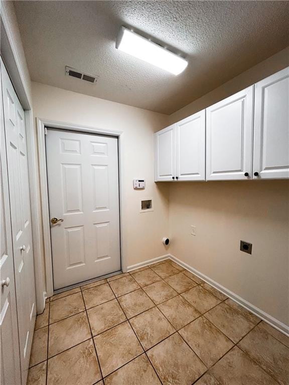 3077 Oakside Cir, Alpharetta, GA 30004 - clothes washing area with hookup for an electric dryer, cabinet space, a textured ceiling, light tile patterned floors, and baseboards