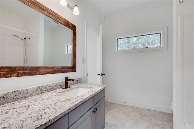 bathroom featuring a tile shower, vanity, toilet, and ornamental molding