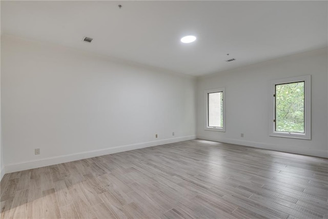 empty room featuring light hardwood / wood-style floors and a healthy amount of sunlight