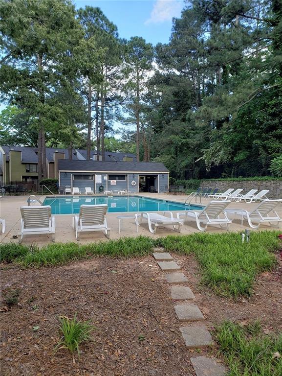 view of swimming pool featuring a patio area and an outbuilding