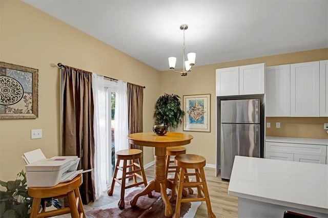 dining area with a chandelier and light wood-type flooring