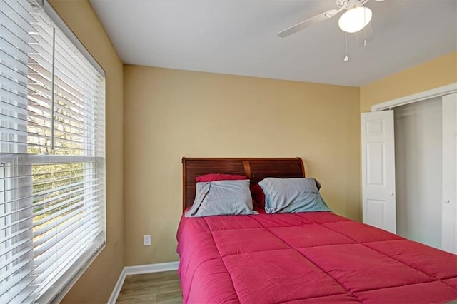 bedroom with ceiling fan and hardwood / wood-style floors