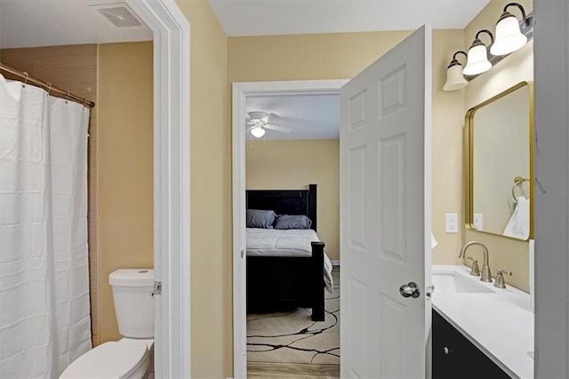 bathroom featuring vanity, ceiling fan, and toilet