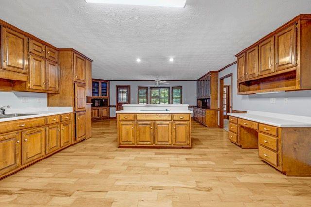 362 Clyde Ct, Mcdonough, GA 30252 - kitchen with a sink, brown cabinets, a textured ceiling, and recessed lighting