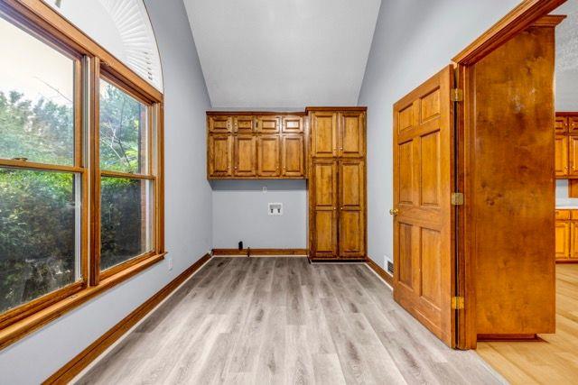 362 Clyde Ct, Mcdonough, GA 30252 - laundry area with light wood-style floors, cabinet space, baseboards, and hookup for a washing machine