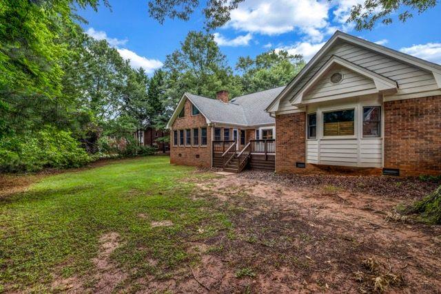 362 Clyde Ct, Mcdonough, GA 30252 - rear view of property featuring brick siding, crawl space, and a lawn