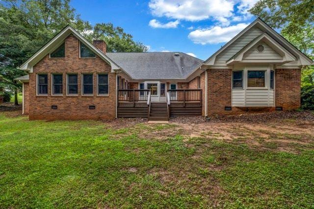 362 Clyde Ct, Mcdonough, GA 30252 - back of house with crawl space, a lawn, a wooden deck, a chimney, and brick siding