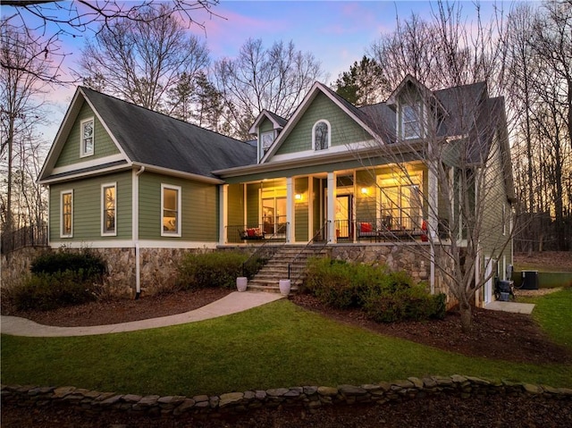 craftsman inspired home with covered porch and a front lawn