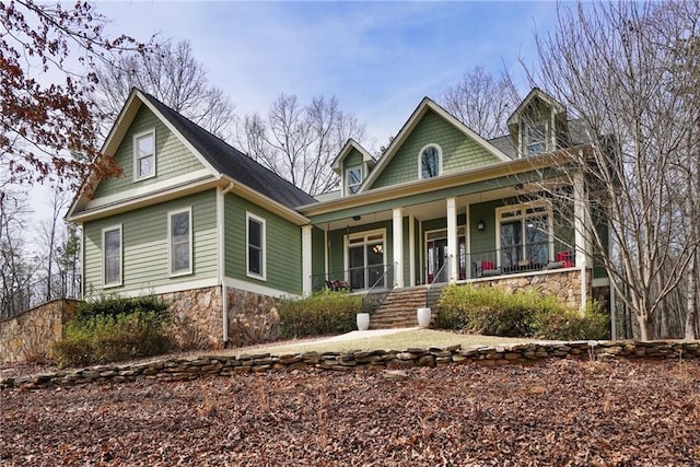 view of front of home with covered porch and stone siding