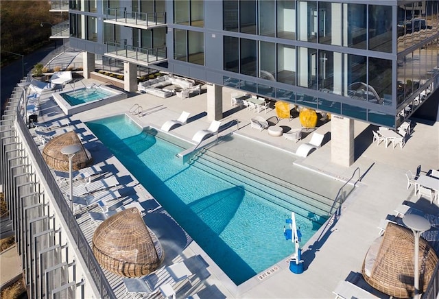 view of pool with a community hot tub and a patio area