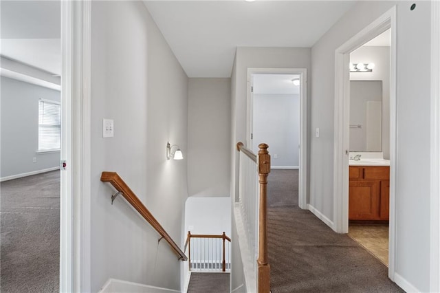 stairway with carpet floors and sink