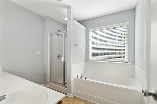 bathroom with vanity and shower with separate bathtub