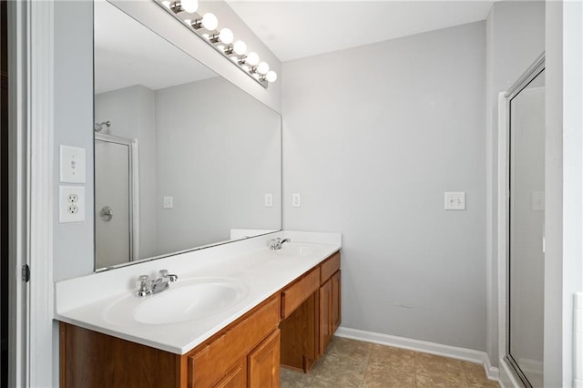 bathroom featuring a shower with shower door and vanity