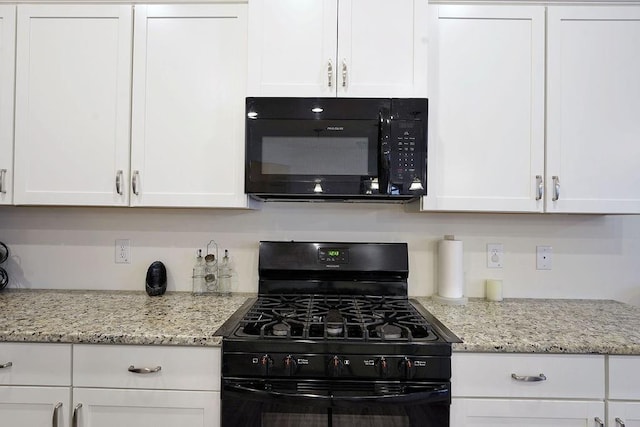 kitchen featuring white cabinetry, light stone countertops, and black appliances