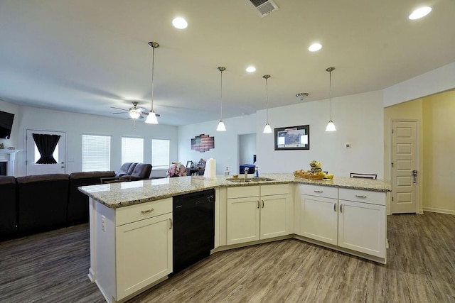 kitchen featuring white cabinets, decorative light fixtures, light stone countertops, and dishwasher