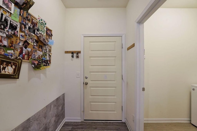 doorway with dark wood-type flooring