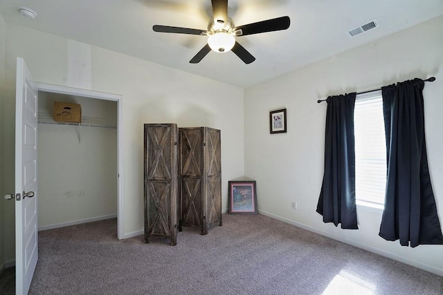 unfurnished bedroom with ceiling fan and carpet