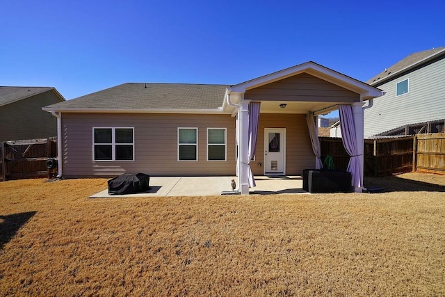 rear view of house with a lawn and a patio area