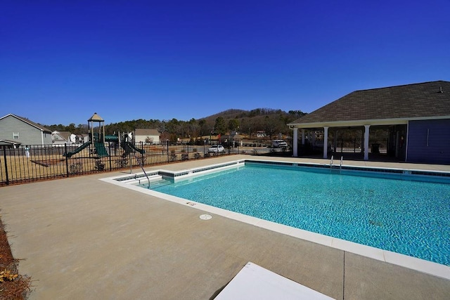 view of pool with a playground