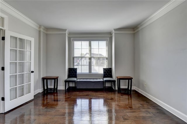 sitting room with ornamental molding, baseboards, and wood finished floors